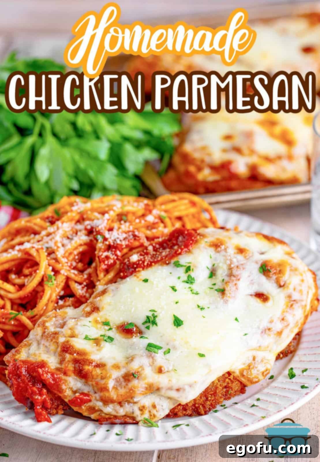 A plate in the foreground with a serving of homemade chicken parmesan.