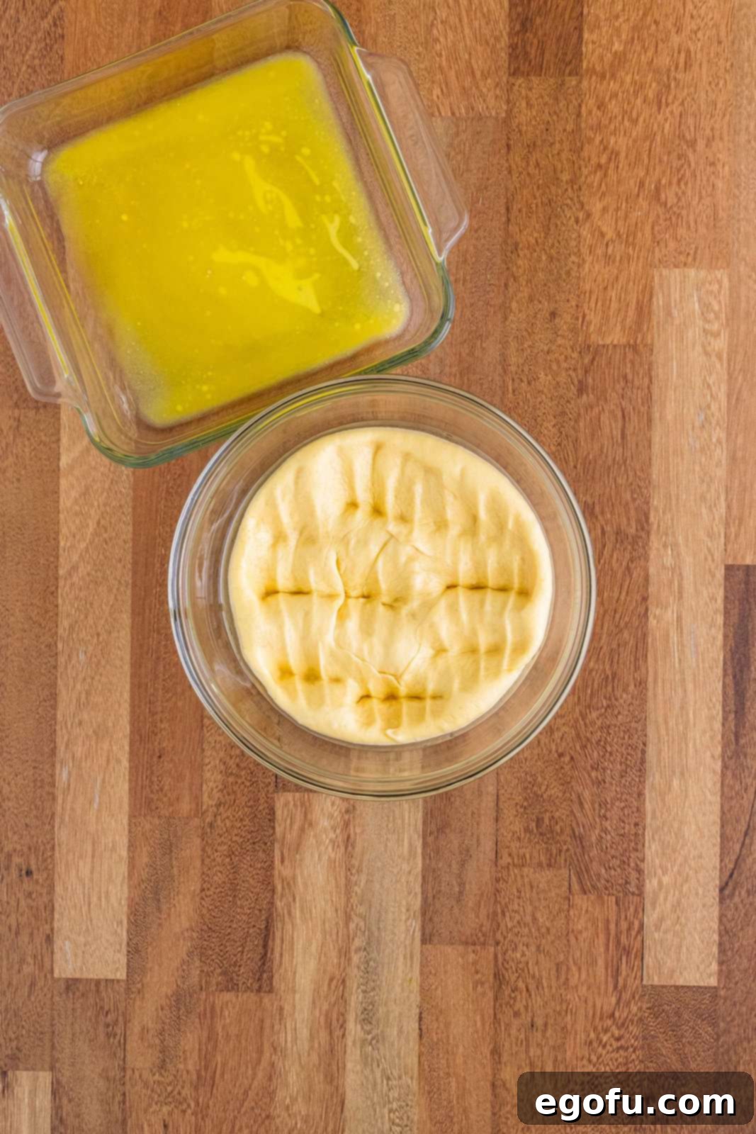 Butter Bathed Cloud Rolls 11 A mixing bowl with yeast roll dough after it has been punched down, releasing air and preparing for the next shaping step.