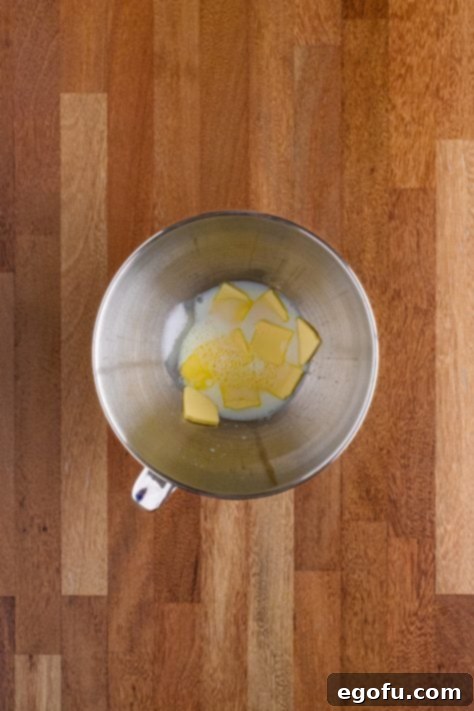Butter Bathed Cloud Rolls 20 Mixing bowl with butter, sugar, and warmed milk.