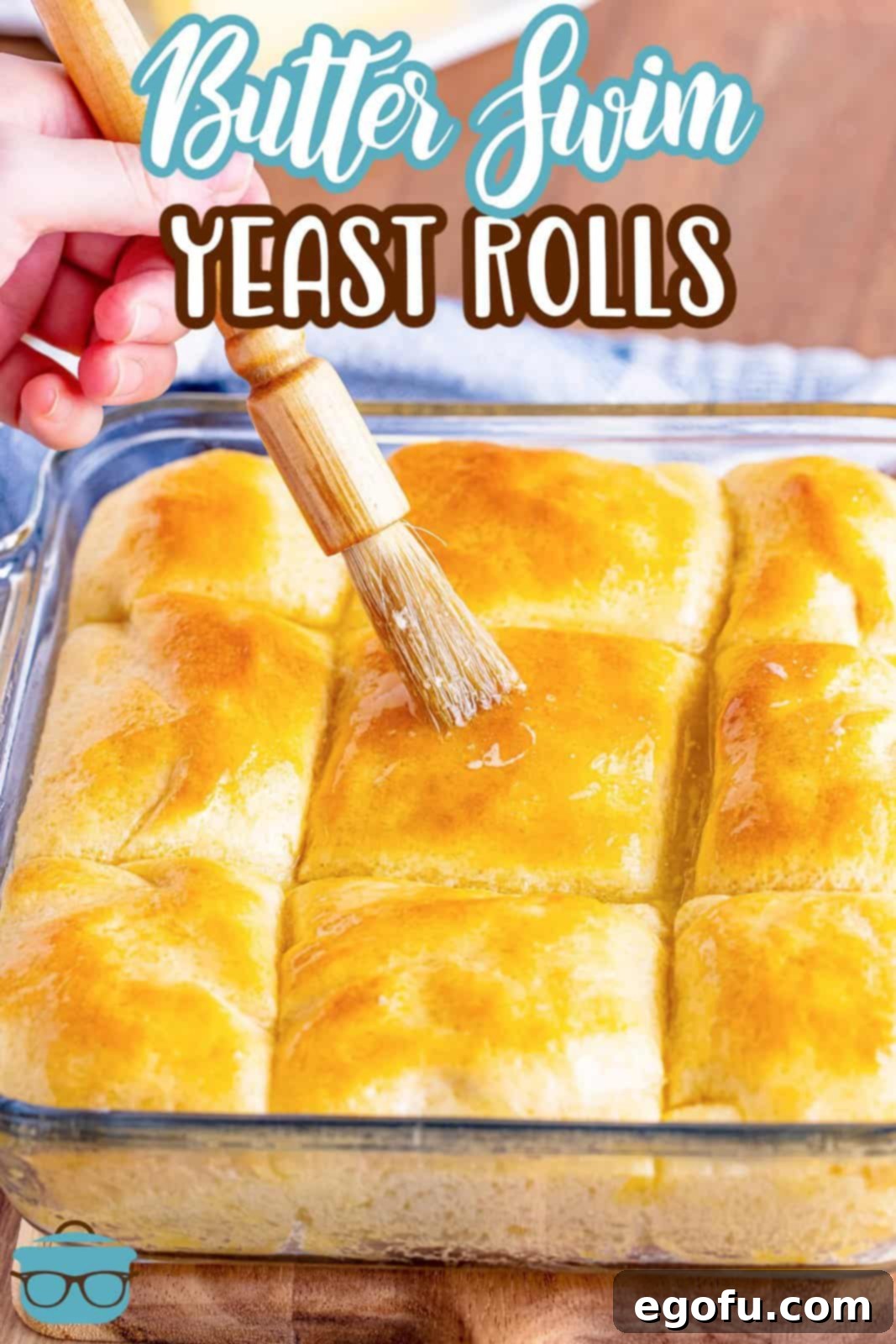 Butter Bathed Cloud Rolls 3 A pastry brush applies a final glistening layer of melted butter to hot yeast rolls in a baking pan.