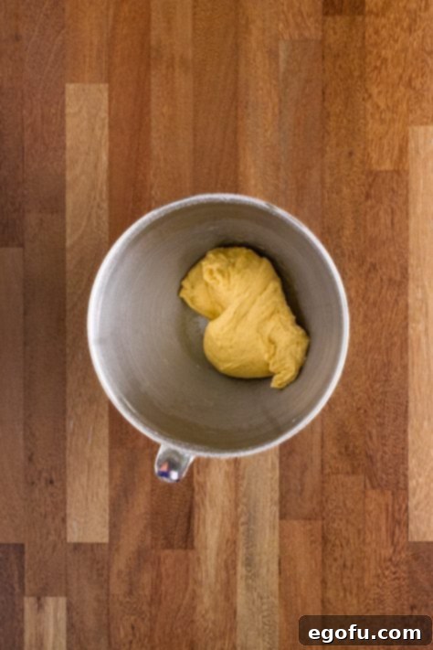 Butter Bathed Cloud Rolls 23 A bowl of a stand mixer with yeast bread roll dough.