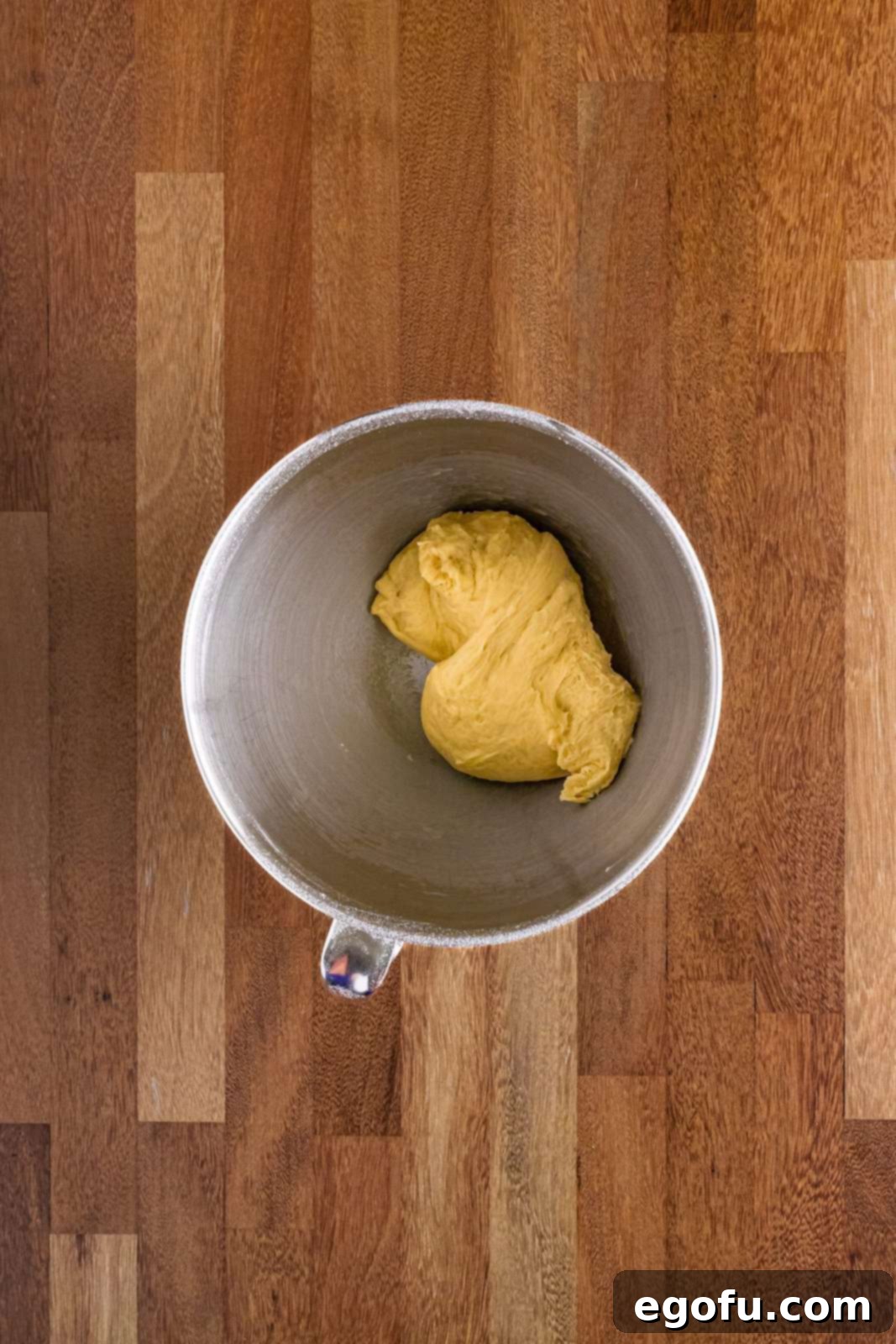 Butter Bathed Cloud Rolls 9 Well-kneaded yeast bread roll dough in a stand mixer bowl, showing a smooth and elastic texture.