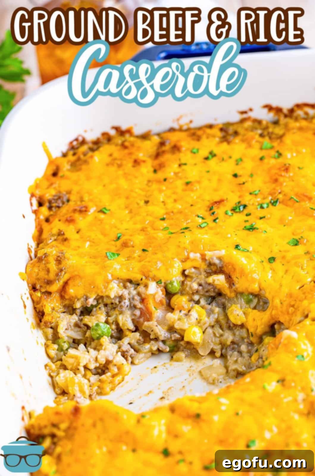 Golden Cheesy Beef and Rice Bake 3 A casserole made of ground beef and rice with a serving spoon removing a portion.