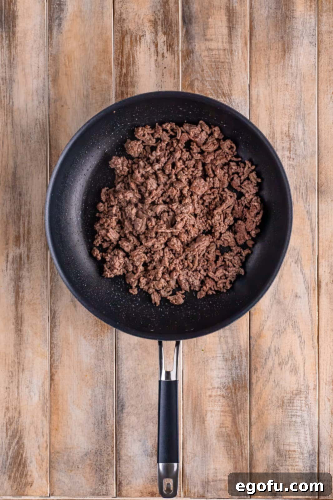Slow Cooker Humble Stew 5 Skillet with cooked ground beef, evenly browned and crumbled.