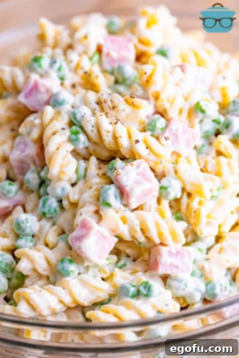 Ruby Tuesday Inspired Creamy Pasta Salad 15 A close up of a pasta salad with pasta, peas, and ham.
