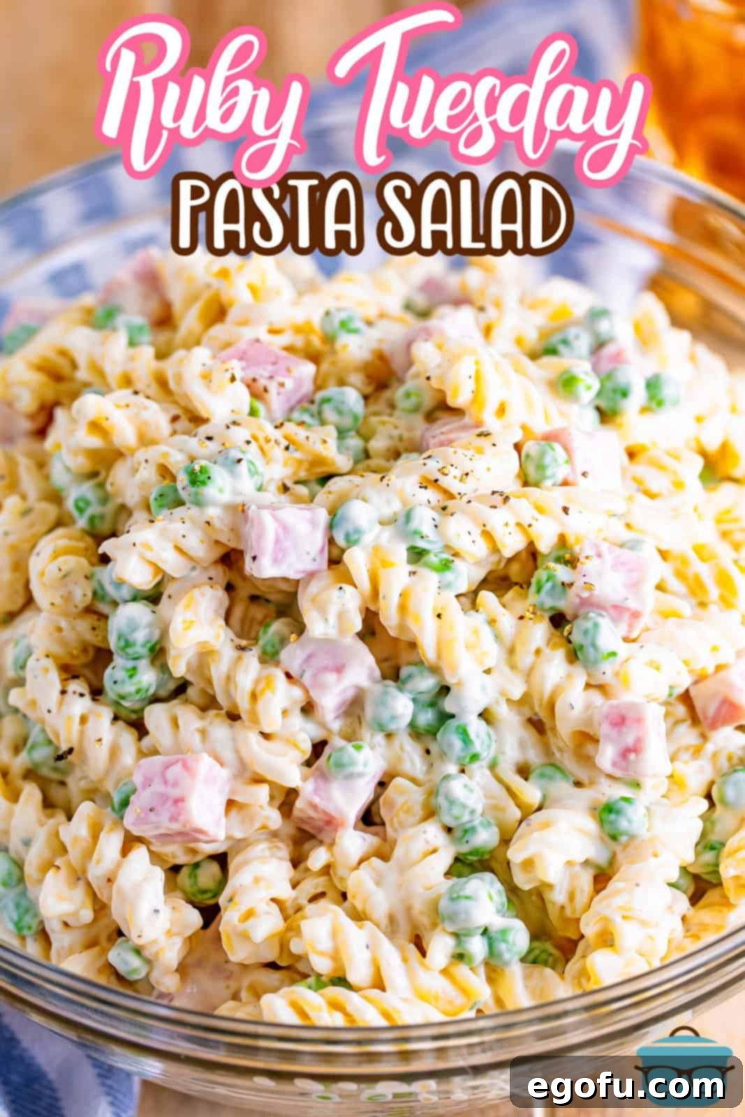 Ruby Tuesday Inspired Creamy Pasta Salad 4 A glass bowl of rotini, pasta, ham, and sauce.