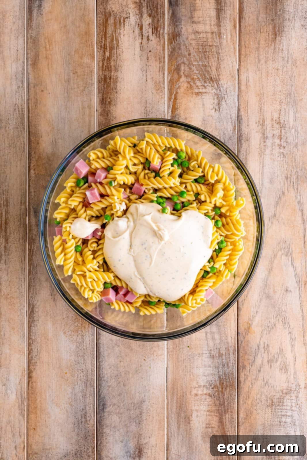 Ruby Tuesday Inspired Creamy Pasta Salad 8 A bowl of rotini pasta, ham, peas, and mayo based dressing.