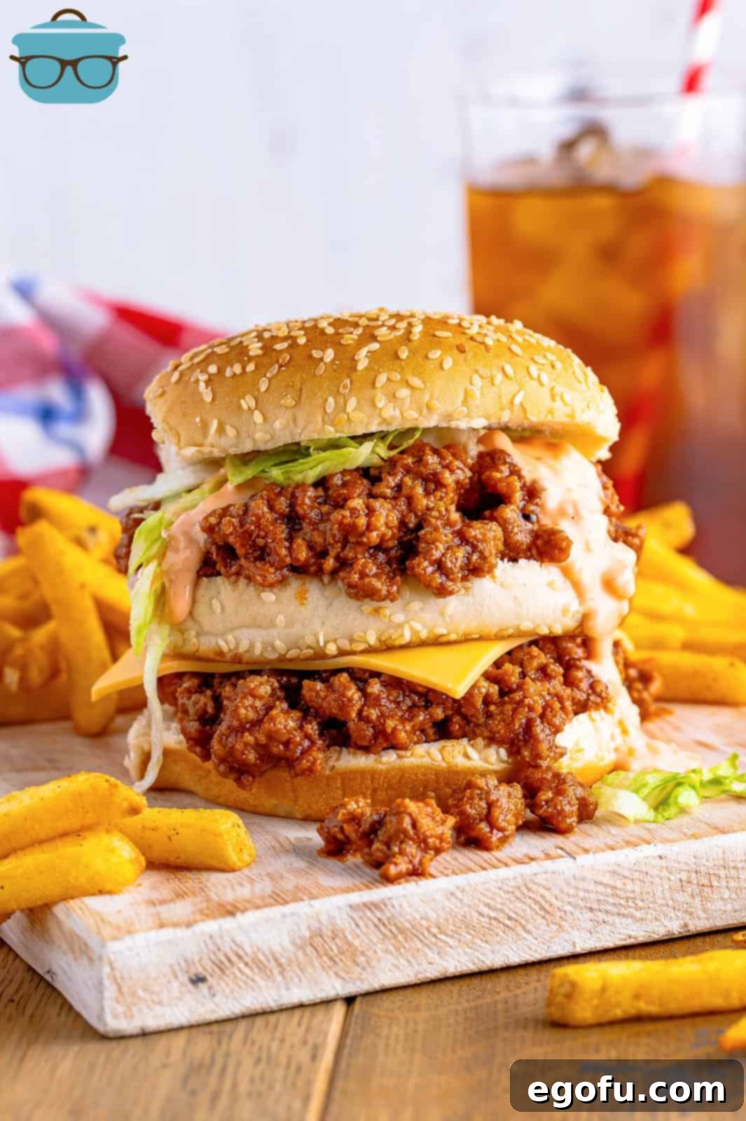 Mac Attack Sloppy Joes 8 A plate holding a messy sloppy joe sandwich and fries.