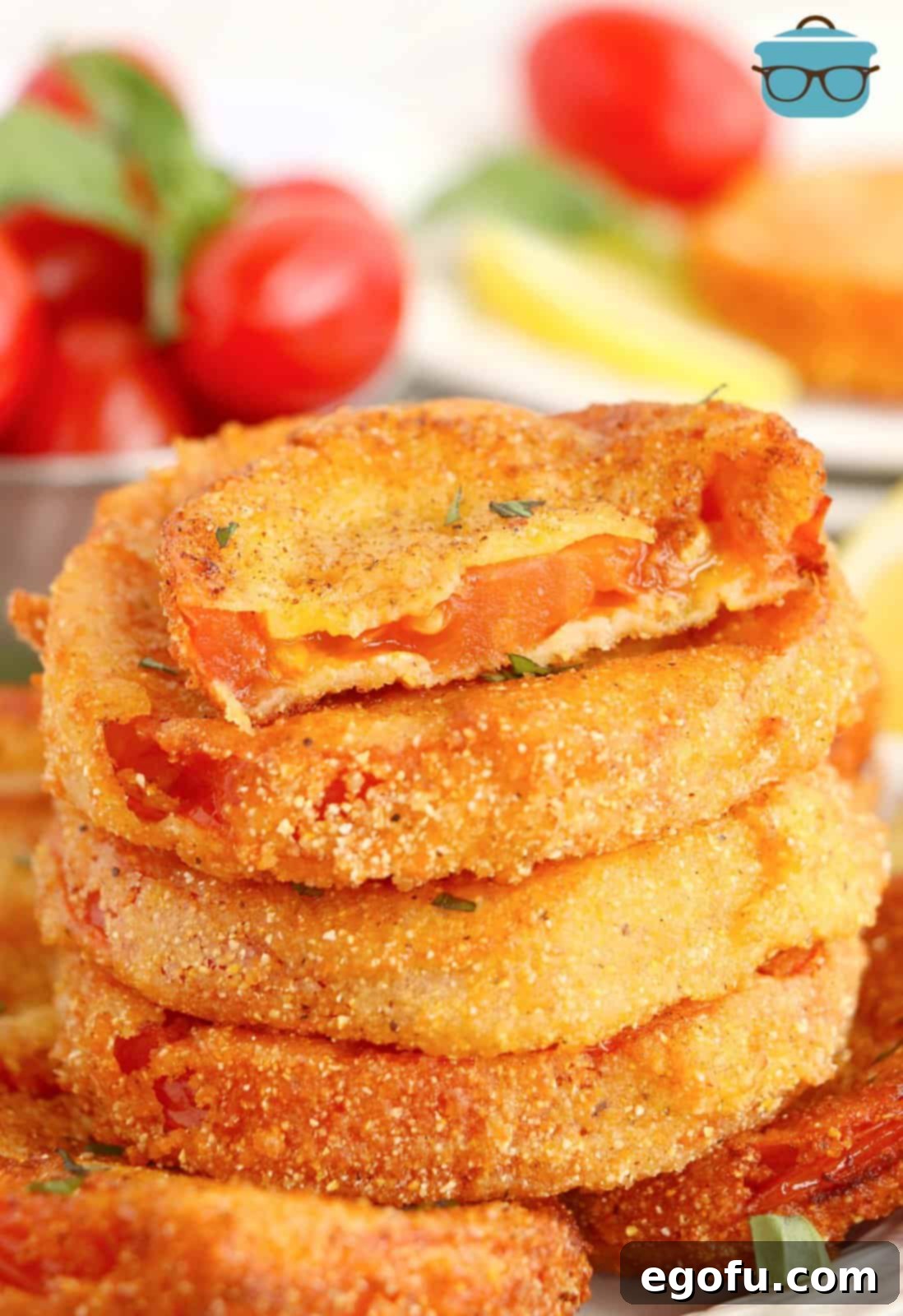 A stack of breaded and Fried Red Tomatoes. 
