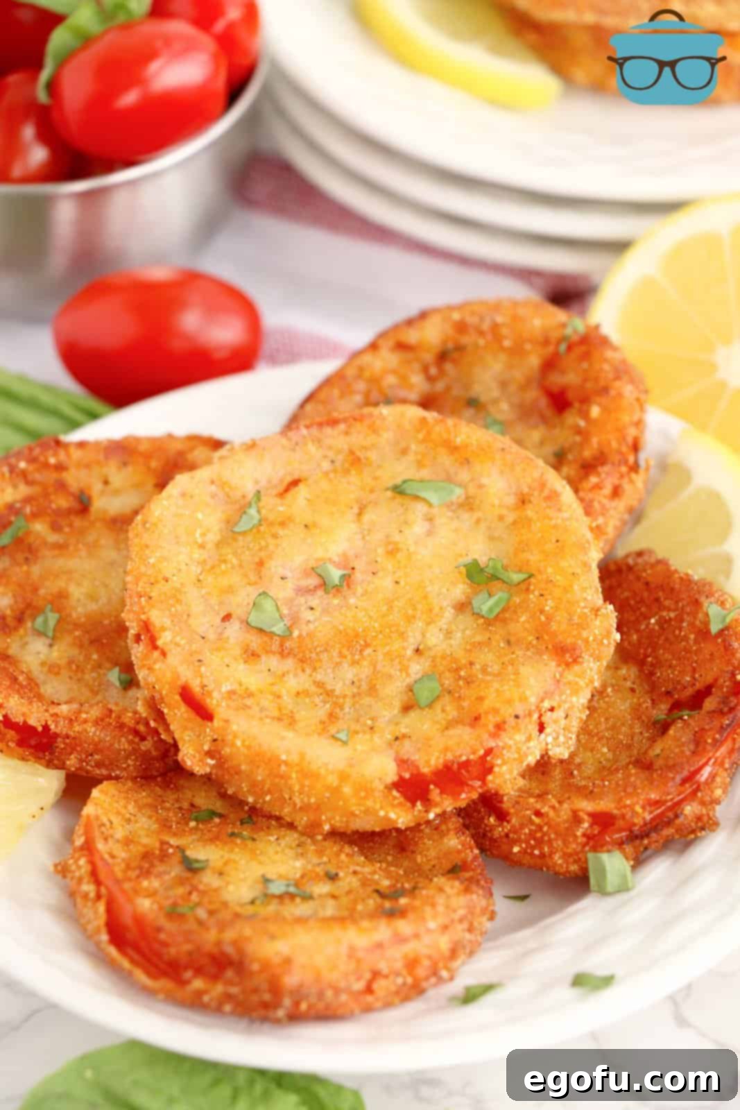 A plate of breaded and fried red tomatoes.