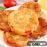 A stack of Fried Red Tomatoes on a plate.