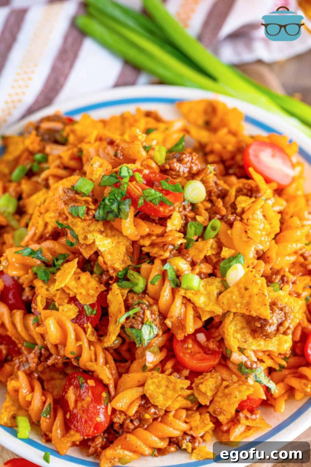 A close-up of a plate of rotini taco pasta salad, showcasing its vibrant ingredients and texture.