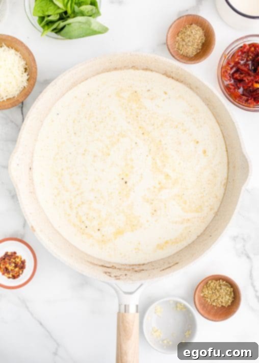 Proposal Chicken 13 Heavy cream, chicken broth, red pepper flakes, spices, thyme, oregano, and Parmesan cheese all in a pan.