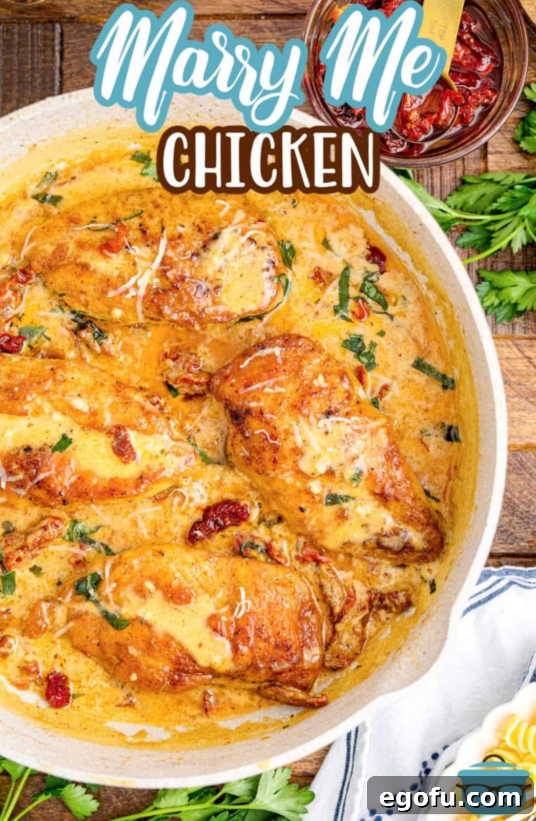 Proposal Chicken 3 A round serving dish with chicken and sauce, garnished with fresh basil.