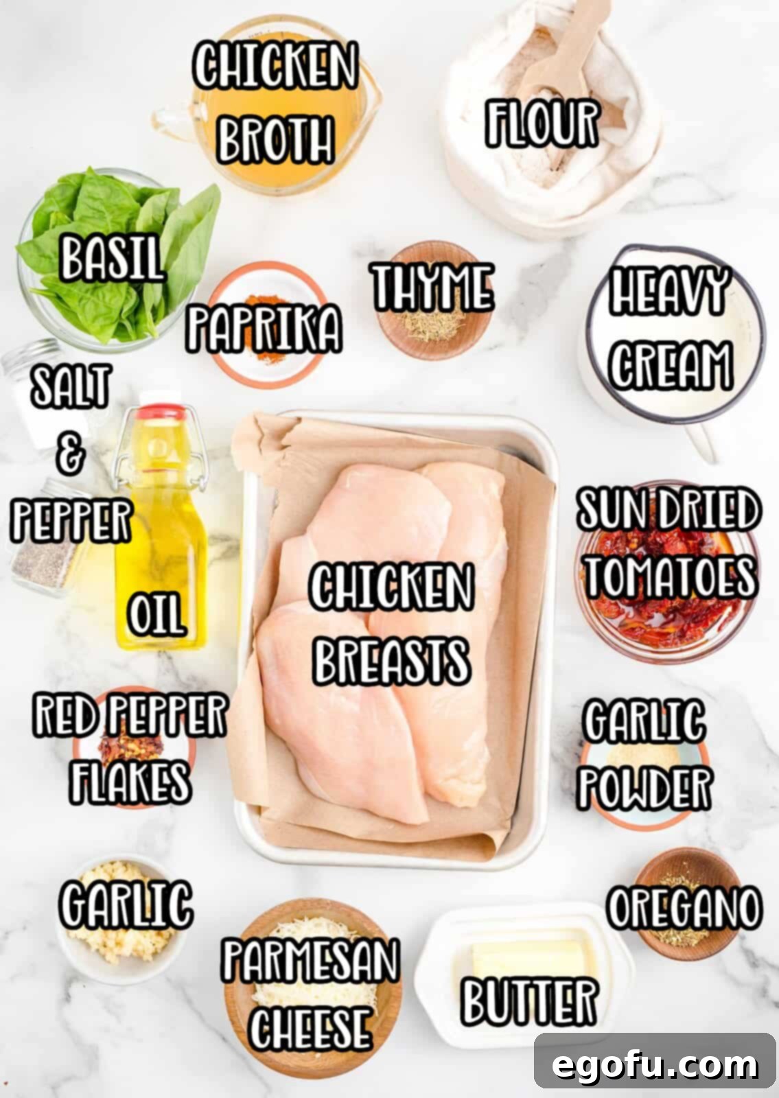 Proposal Chicken 4 Display of Marry Me Chicken ingredients: chicken breasts, all-purpose flour, salt, pepper, garlic powder, paprika, oil, salted butter, minced garlic, chicken broth, heavy cream, grated Parmesan cheese, red pepper flakes, oregano, thyme, and chopped sun-dried tomatoes.