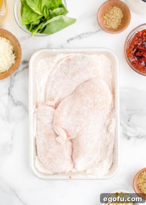 Proposal Chicken 10 A pan with flour coated chicken breasts.