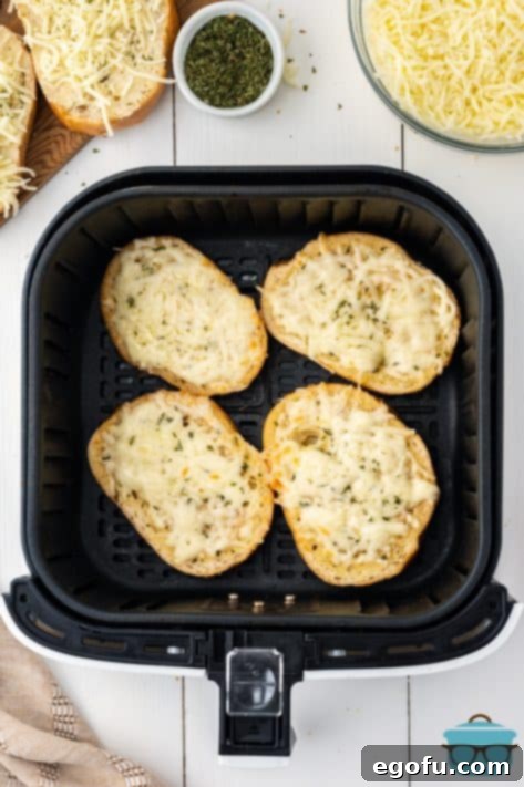 An Air Fryer basket with 4 slices of garlic bread.