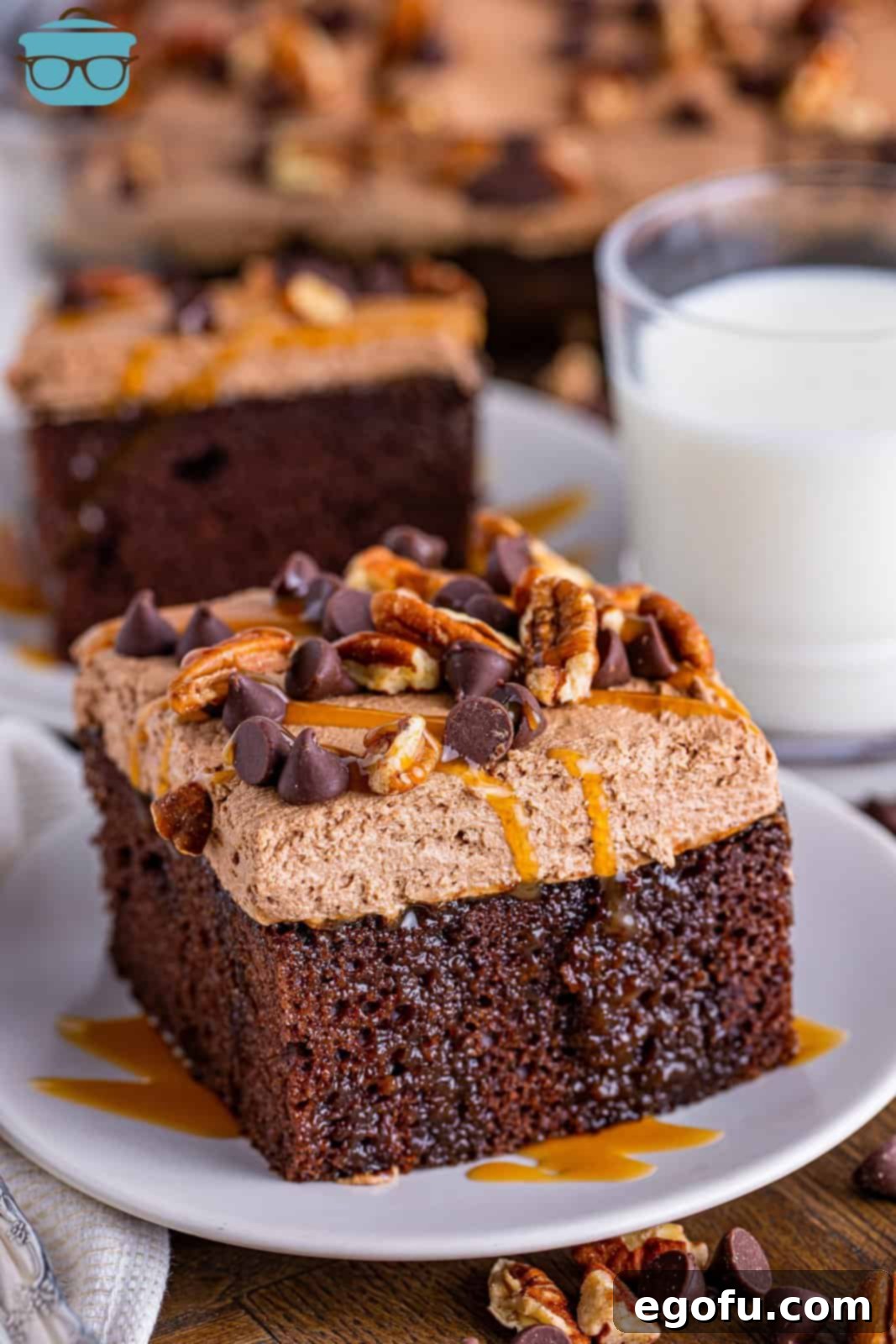 A slice of Turtle Poke cake on a plate. 
