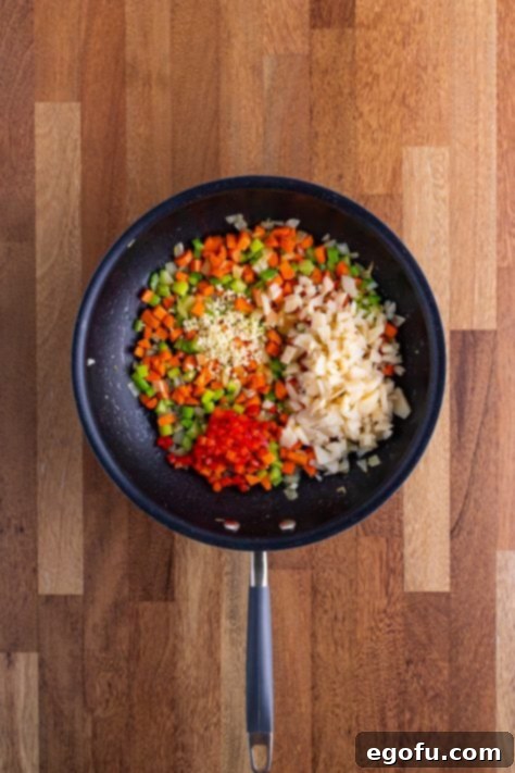 Skillet with celery, butter onion, garlic, pimentos and water chestnuts and carrots all mixed together and sauteed.