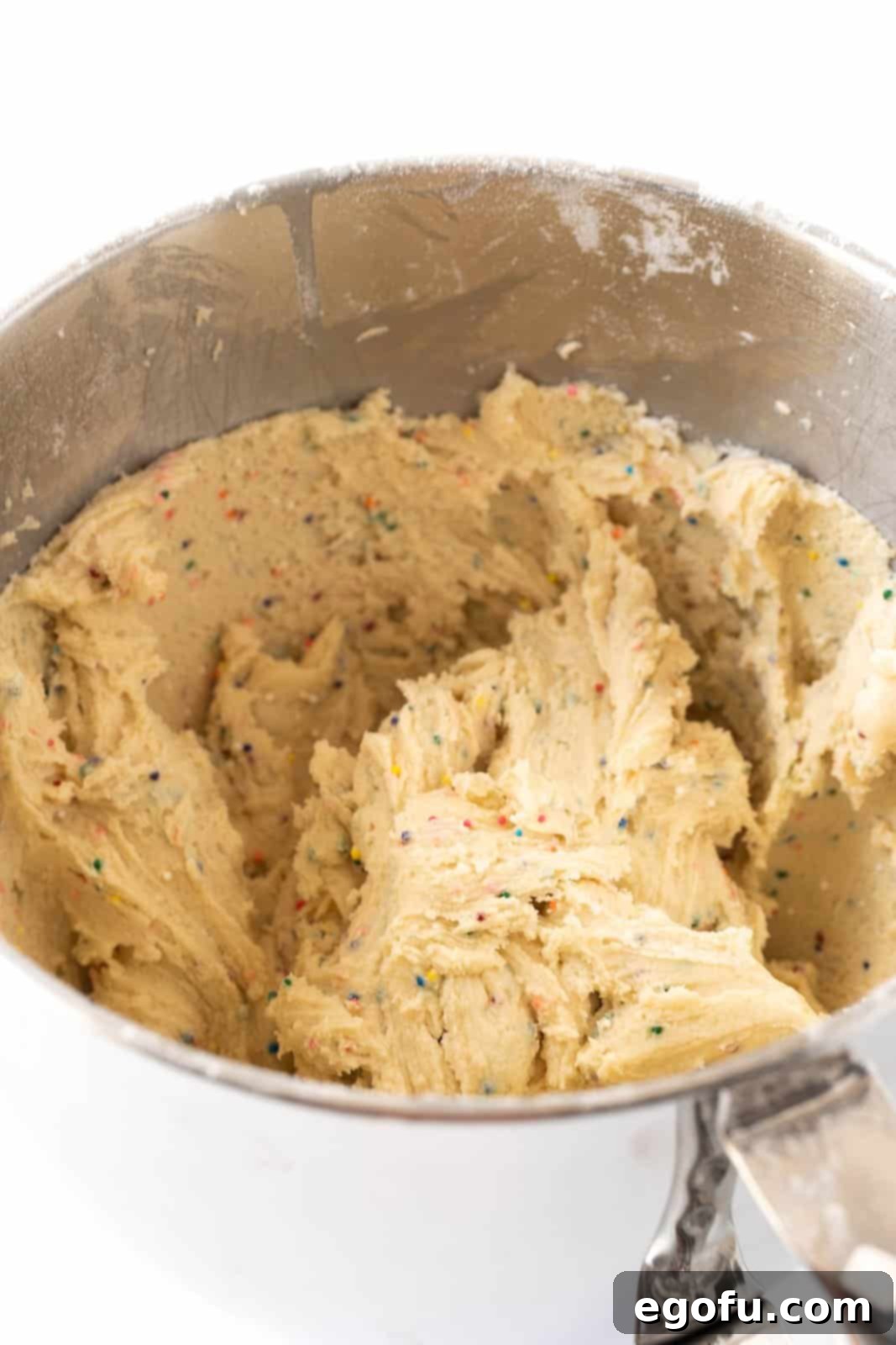 A mixing bowl with condensed milk cookie dough, showcasing the perfect consistency before shaping.
