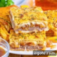 A plate of stacked French Dip Squares, showcasing their golden crust and enticing layers.