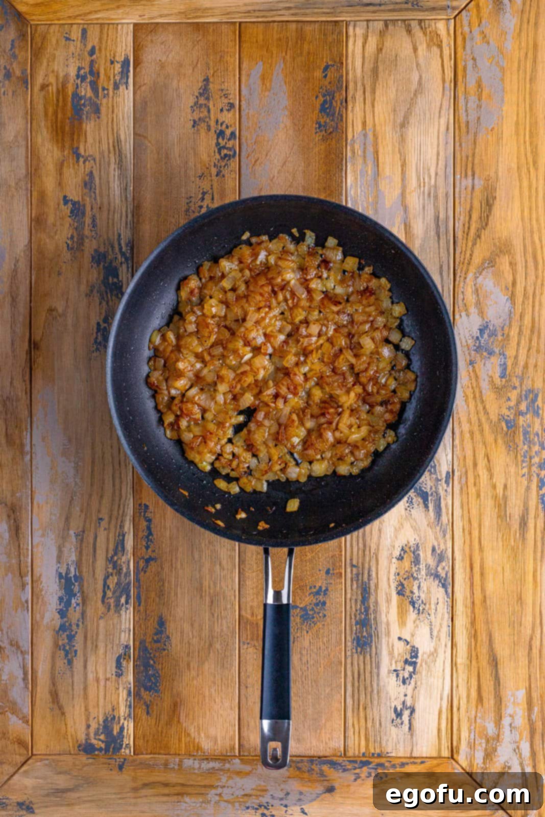 Skillet with perfectly cooked, golden-brown caramelized onions, ready for the next step of the recipe.
