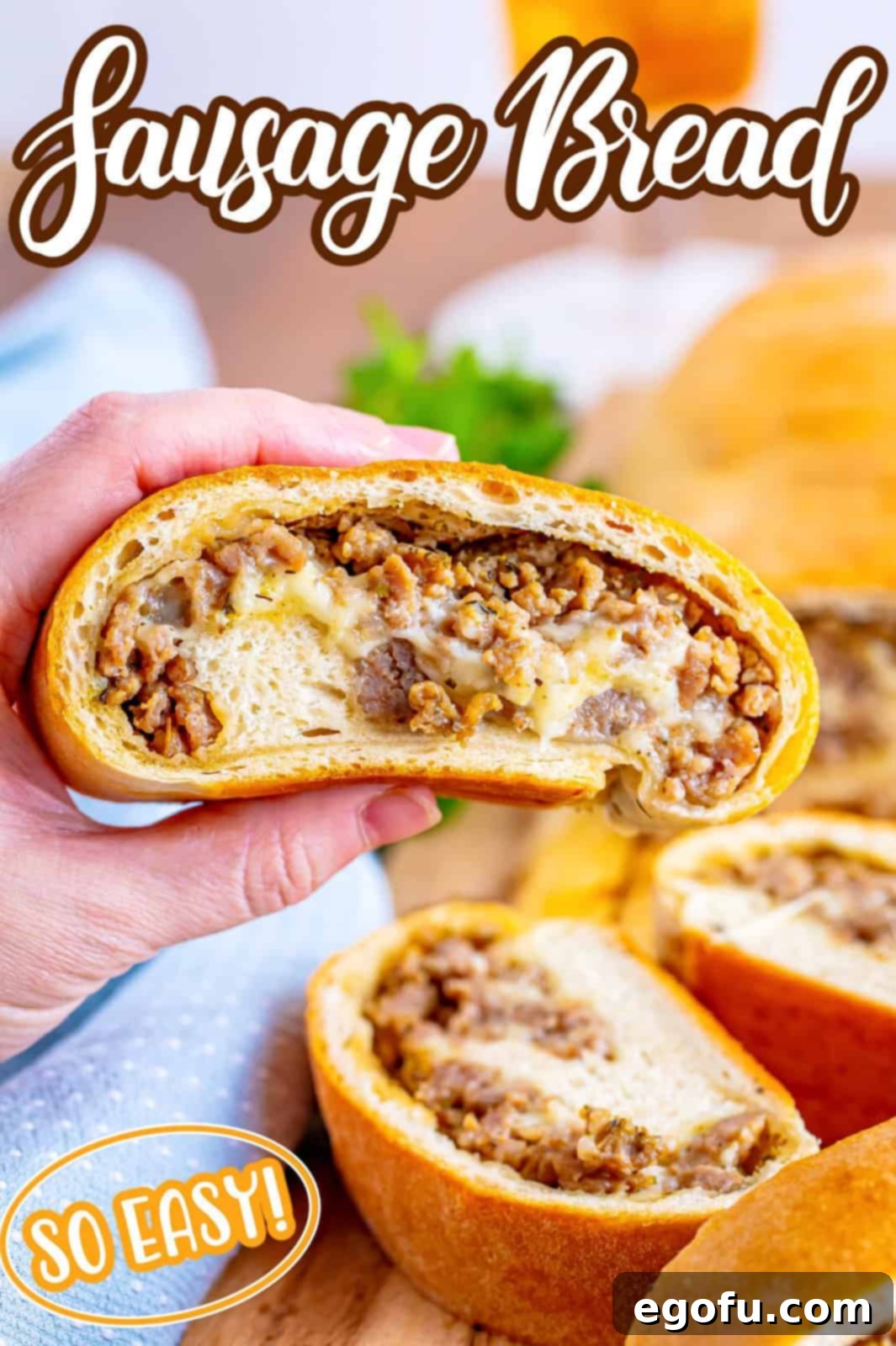 A hand holding a slice of homemade sausage bread above few other pieces, ready to be enjoyed.