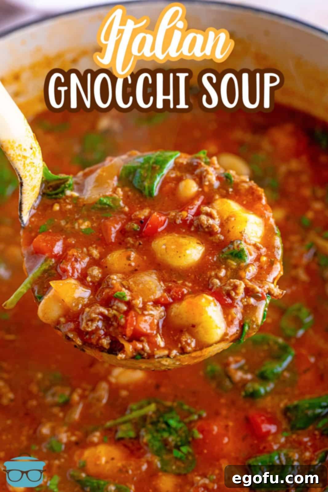 A ladle serving Italian Gnocchi Soup from a large pot, showing the rich tomato broth and tender gnocchi.