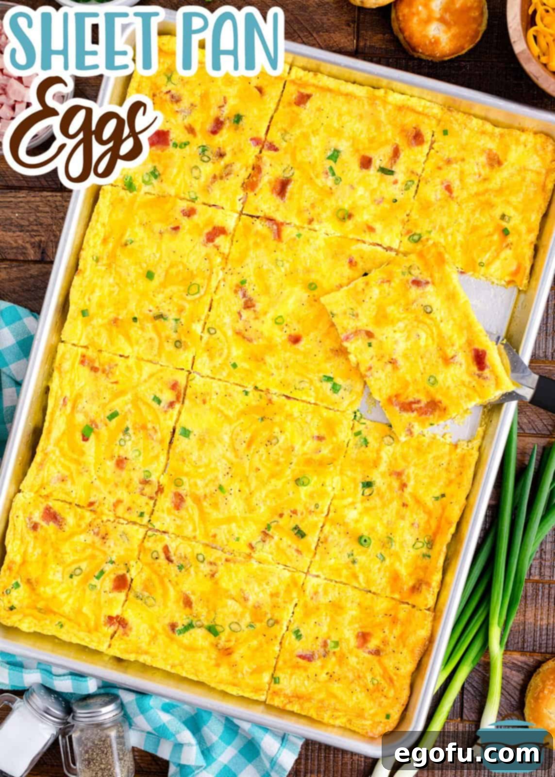 Baked Sheet Pan Eggs 3 An angled shot of a baking tray filled with a beautifully baked sheet of eggs, showing off its golden-brown top and rich, bubbly toppings, just removed from the oven.