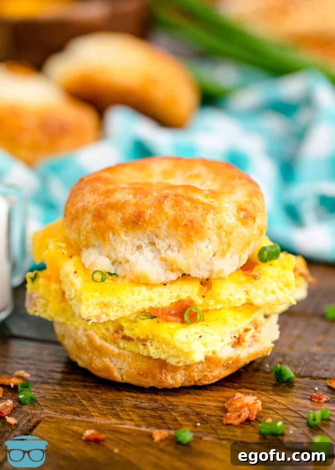 Baked Sheet Pan Eggs 9 A mouth-watering biscuit sandwich featuring a fluffy piece of homemade Sheet Pan Eggs, offering a delightful and convenient breakfast option, perfect for on-the-go mornings.