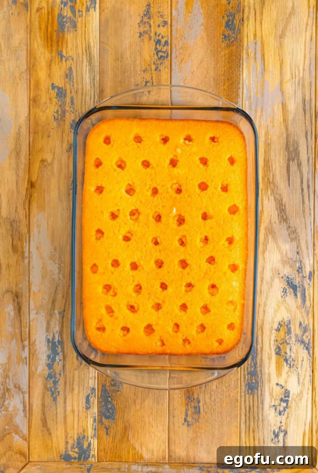 A cake with holes poked in the top and jello poured in the holes.