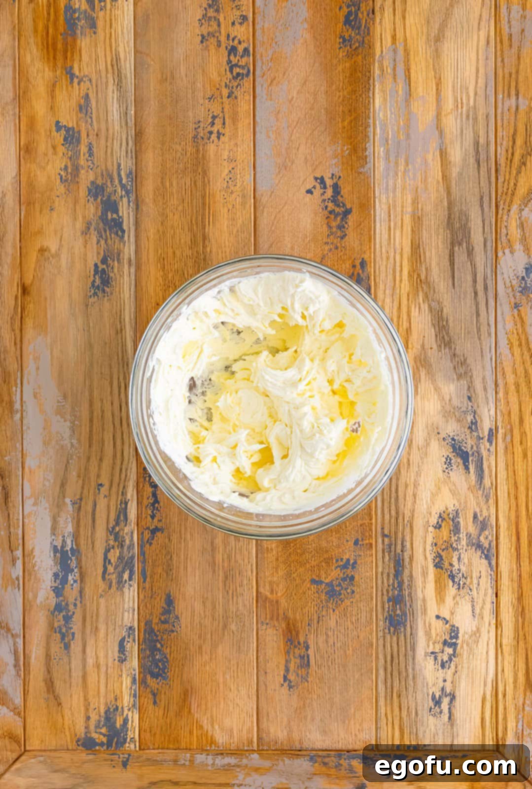 A mixing bowl with butter and powdered sugar mixed together.