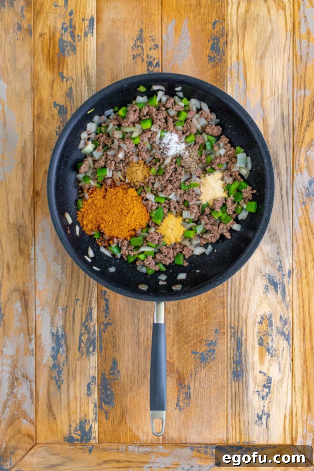 Cooked ground beef, onion, bell pepper, and spices on top.