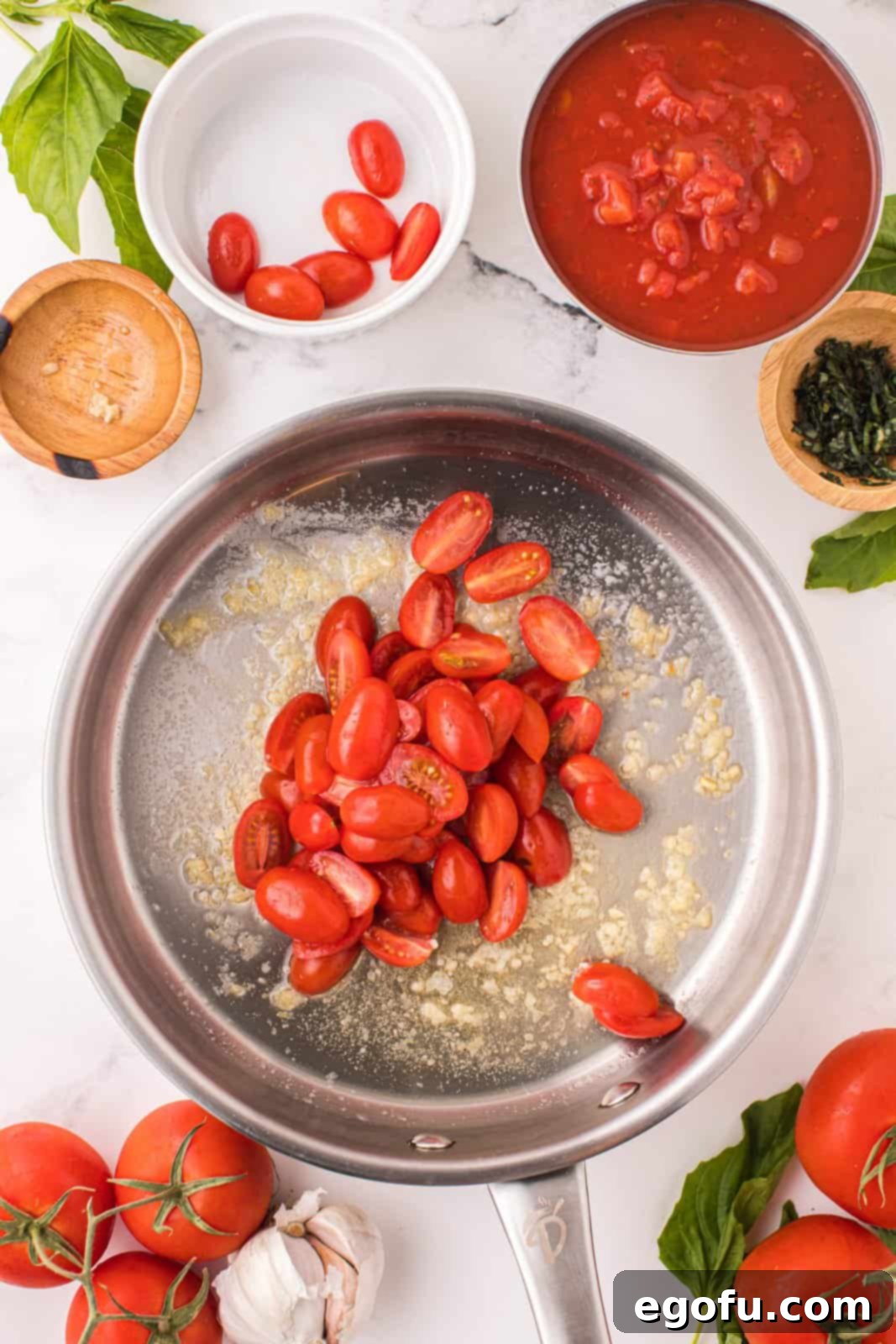 Penne with Garden Tomato Sauce 6 A pan with melted butter, tomatoes and garlic in it.