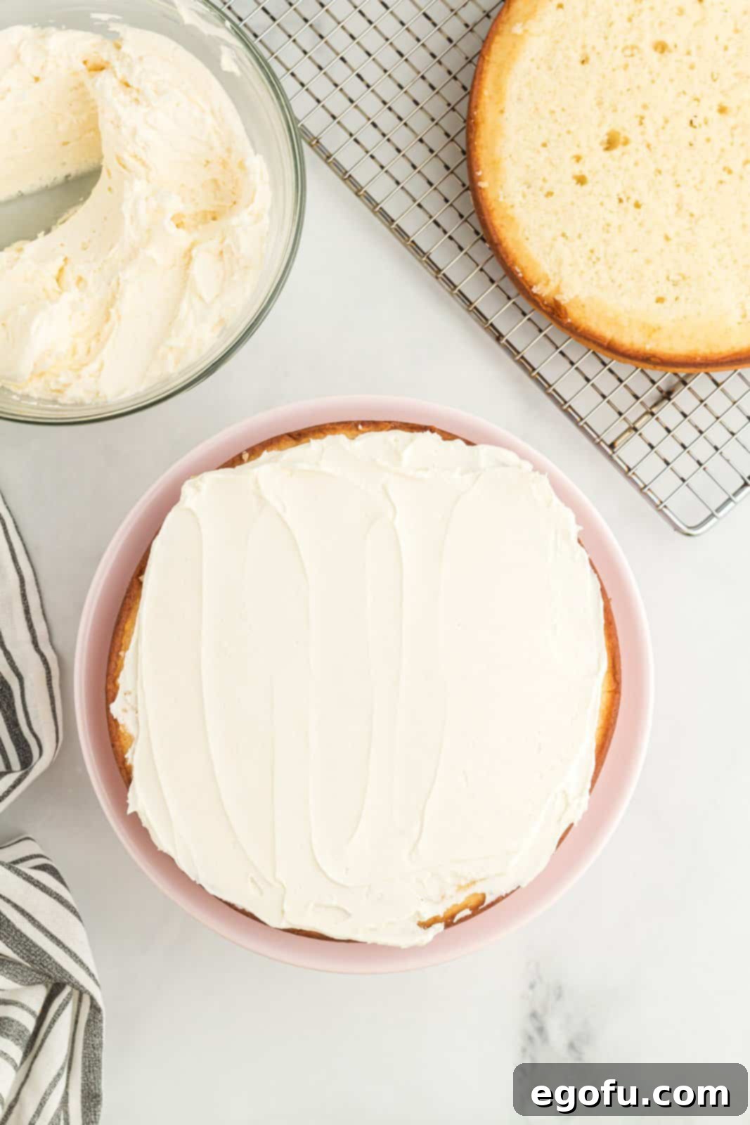 A white cake with homemade frosting on top.