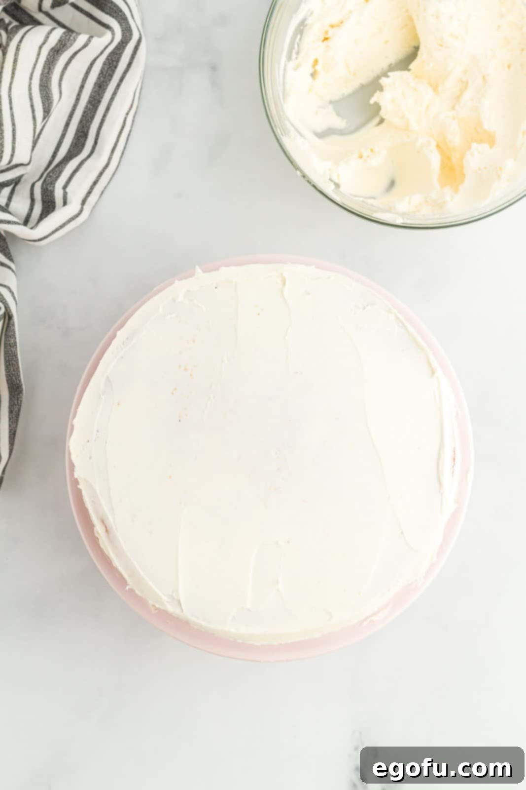 A homemade white cake with frosting.