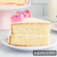 A decorated slice of homemade white cake on a plate.