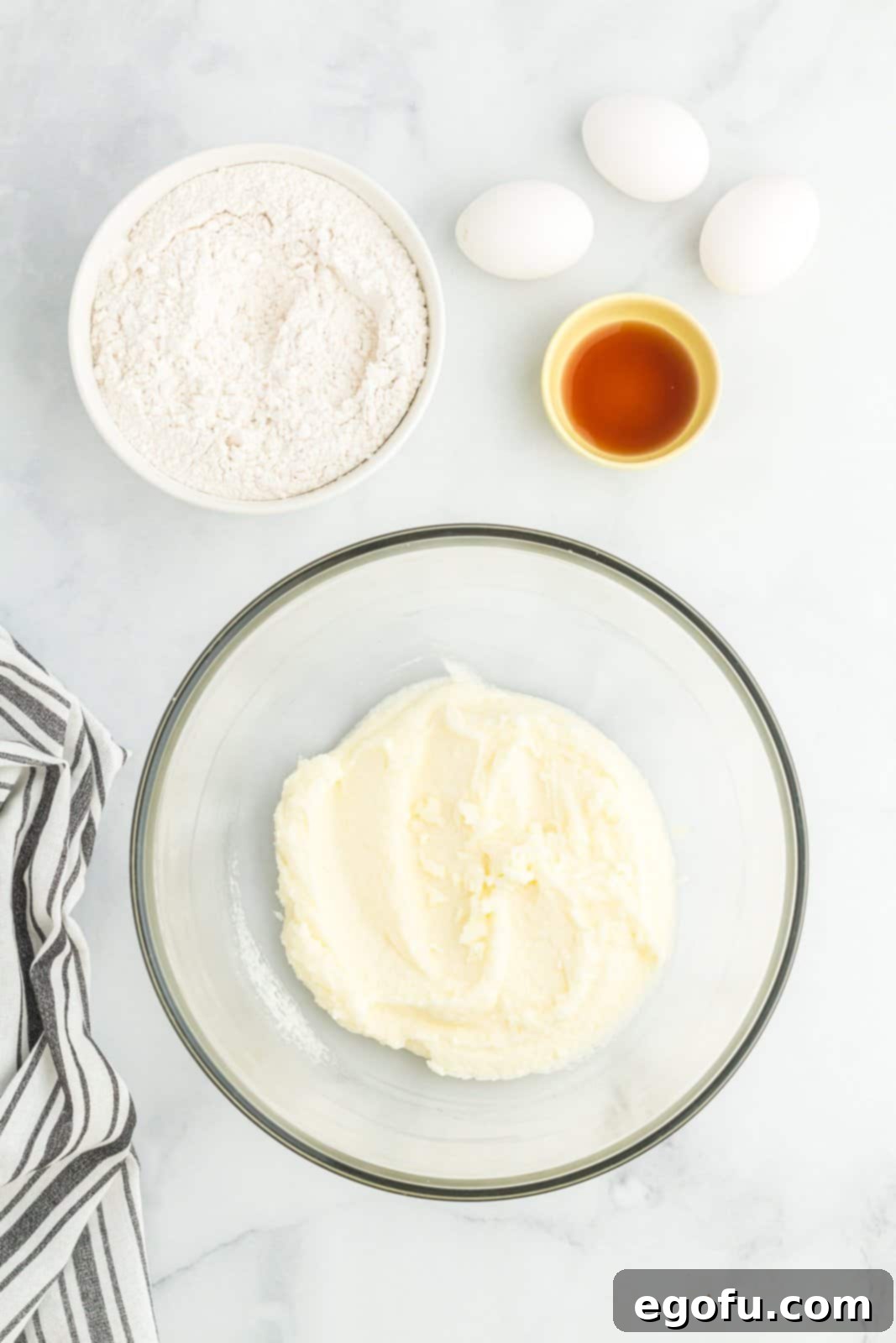 A few containers with ingredients like flour, baking powder, salt, eggs, and vanilla extract.