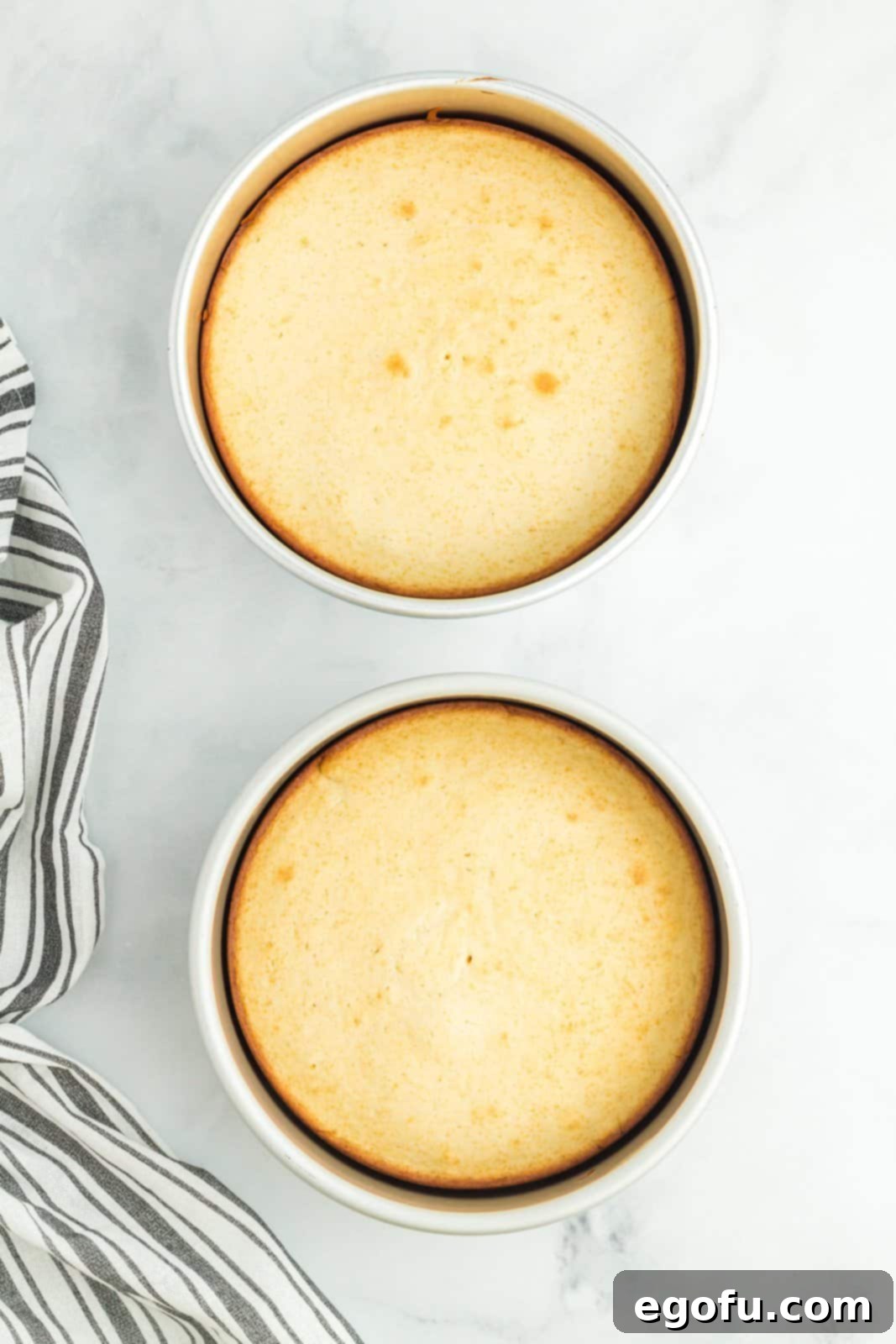 Two pans with homemade white cakes.