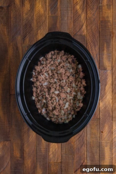 Comforting Slow Cooker Shepherd's Pie 12 Crock pot with ground beef and onion.