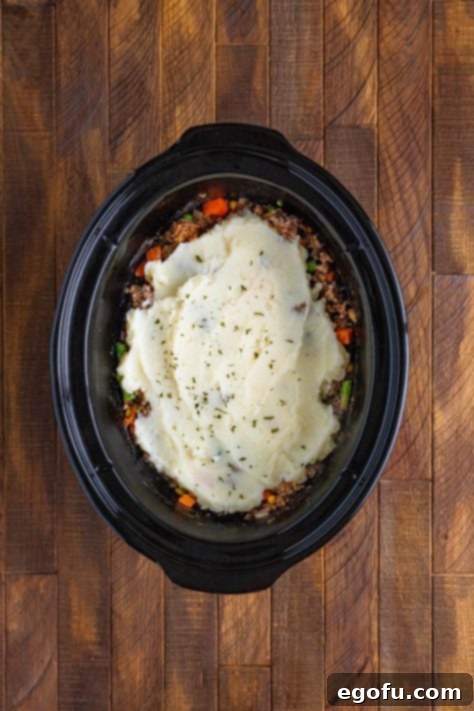 Comforting Slow Cooker Shepherd's Pie 14 Slow Cooker with Shepherd's Pie in it.