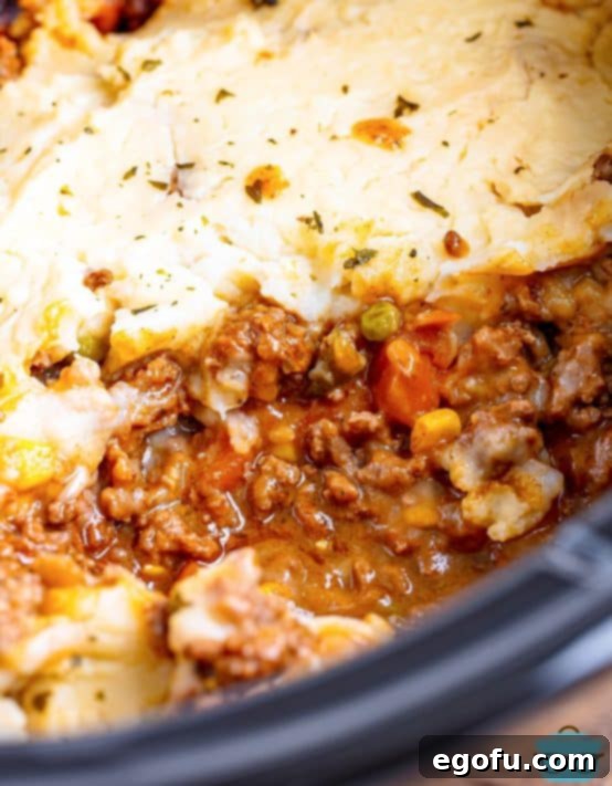Comforting Slow Cooker Shepherd's Pie 15 Slow Cooker Shepherd's Pie with a serving taken out.