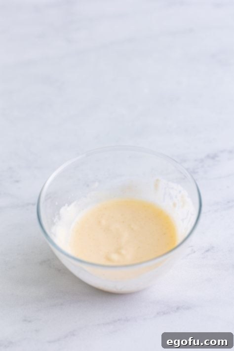 Water and flour mixed together in a bowl.
