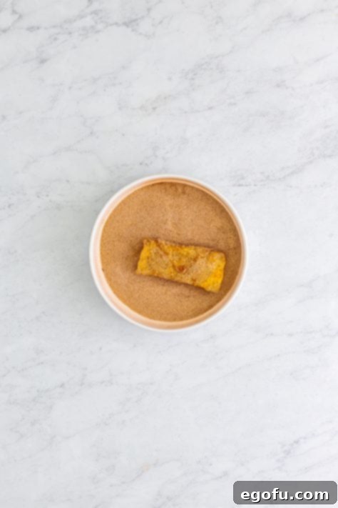 A deep fried Apple Egg Roll in cinnamon and sugar.