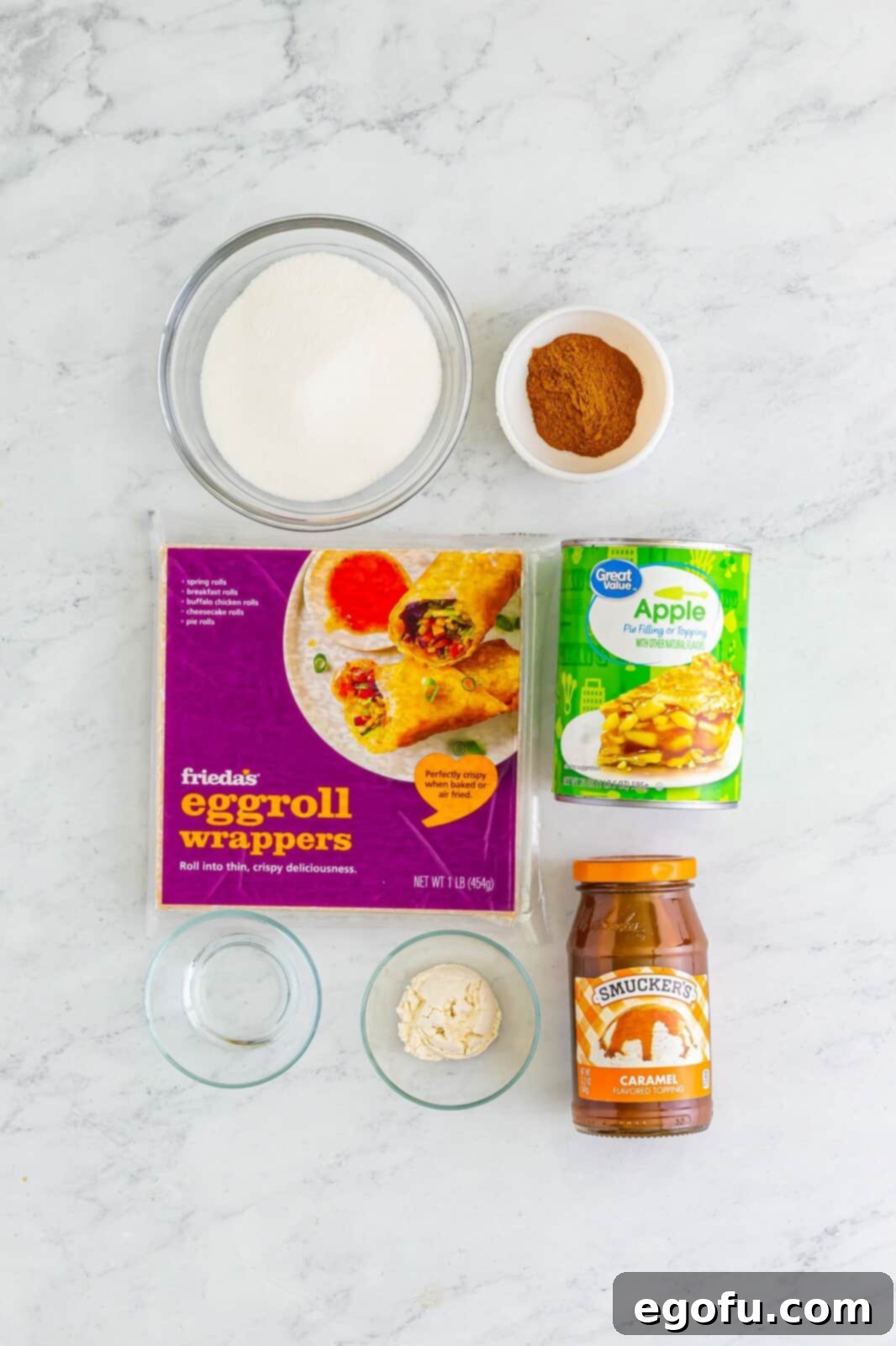 Water, flour, egg roll wrappers, apple pie filling, sugar, cinnamon, and caramel sauce. 