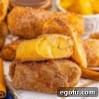 A few Apple Pie Egg Rolls with one open so we can see the filling.