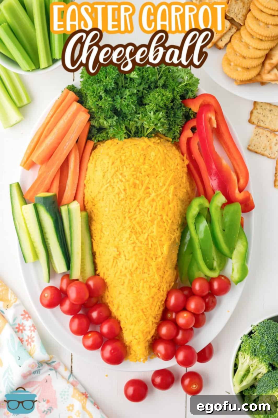 Bunny's Garden Cheeseball 3 A vibrantly shaped carrot cheeseball, artfully arranged on a serving plate and surrounded by an array of fresh, crisp vegetables, inviting guests to dig in.
