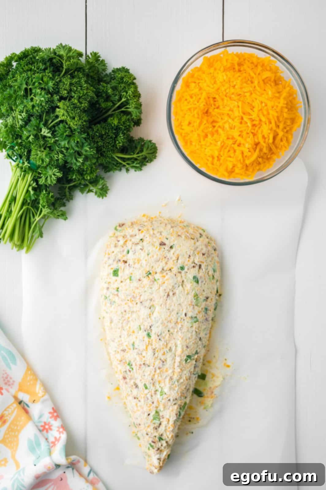 Bunny's Garden Cheeseball 6 A perfectly molded cheeseball taking the festive shape of a carrot, encased between two pieces of parchment paper for easy handling.