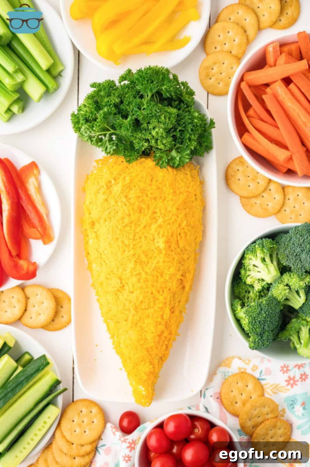 Bunny's Garden Cheeseball 8 The fully coated carrot-shaped cheeseball proudly displayed on an elegant serving plate, awaiting its final touch before chilling.