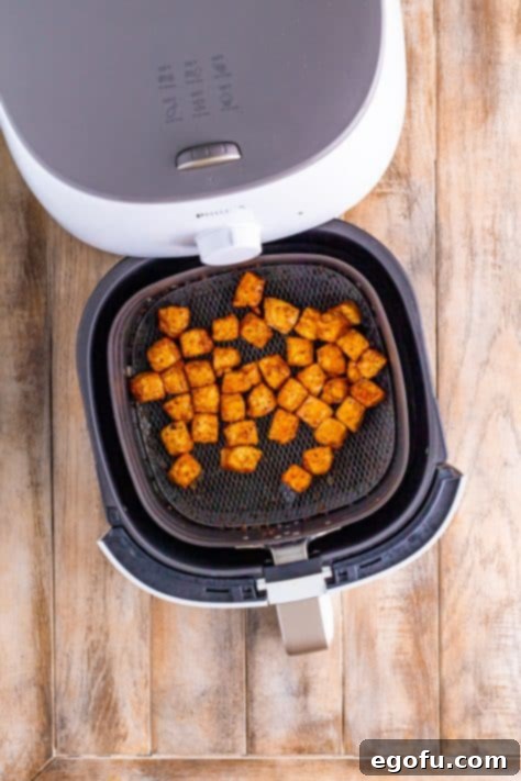 Crispy Air Fried Pork Bites 11 Cooked air fryer pork chop bites sitting in the air fryer basket.